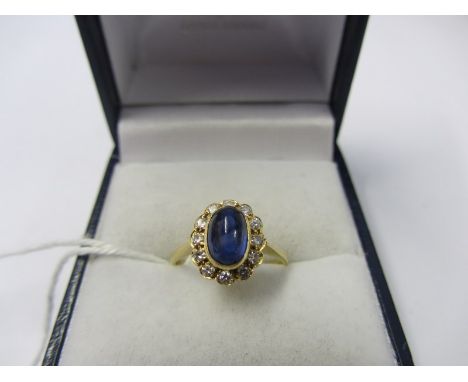 SAPPHIRE & DIAMOND RING, oval cabouchon sapphire surrounded by a cluster of diamonds, on 18ct gold band, size J/K