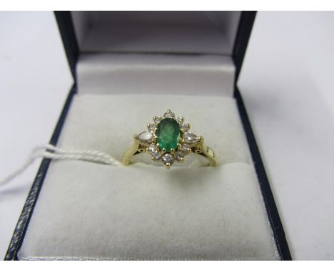 EMERALD & DIAMOND RING, oval emerald surrounded by a cluster of diamonds on 18ct gold band, size L/K