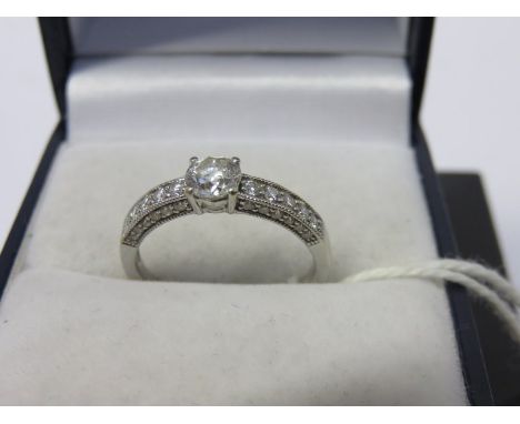 DIAMOND RING, 18ct white gold ring set a central diamond, set 6 further diamonds to each shoulder, size K/L