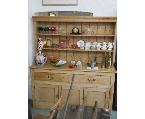 PINE DRESSER, a stripped pine twin cupboard base dresser with 2 frieze drawers and open shelf plate racks, 74" height 76" wid