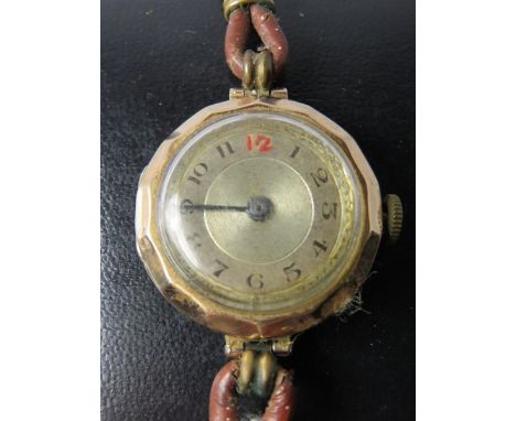 VINTAGE GOLD WATCH, a vintage gold cased wrist watch with Arabic numerals on brown leather strap