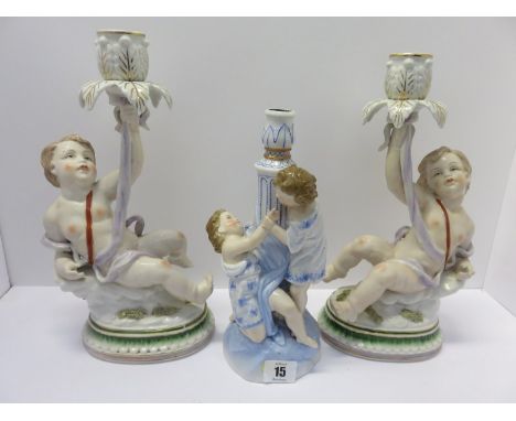 CONTINENTAL CANDLESTICK,  a figure support 10"candle stick, together with pair of gilded porcelain amorini support candlestic