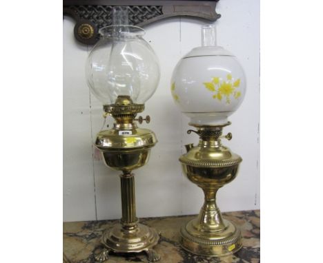 BRASS OIL LAMP, column based oil lamp with clear glass spherical shade and later brass based oil lamp