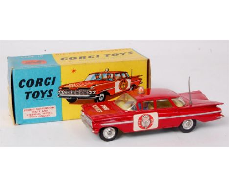 Corgi Toys, 482 Chevrolet Impala fire chief car, red over white body, chrome stripe with round door labels, lemon interior wi