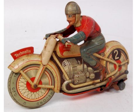 Technofix No.255 Trick Motorcycle - clockwork with light brown/cream Bike, red and blue Rider with 2 to his back and rear whe