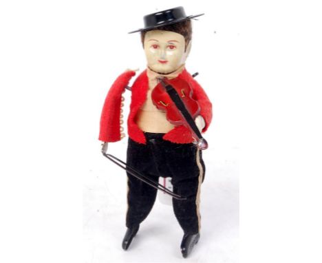 Schuco, tinplate and clockwork violinist, male figure in red jacket and black trousers, with black hat, the bow needs re-alig