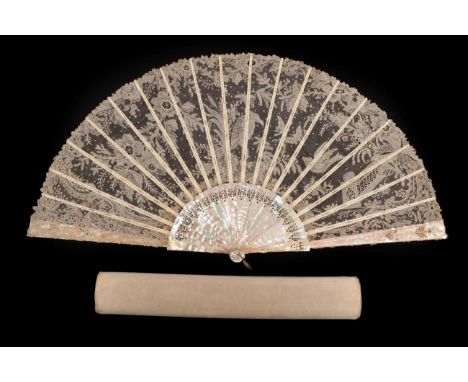 A Fine Large Brussels Point de Gaze Needle Lace Fan, the leaf mounted à l'Anglaise on pink mother of pearl sticks, carved, pi