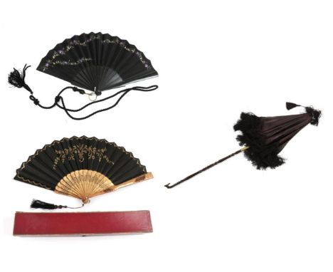 A Circa 1880's Black Silk Fan, mounted on black wood sticks, painted with delicate lilac flowers and green leaves. Probably t
