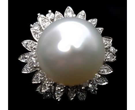 A pearl and diamond dome ring, set in 14ct white gold, the centrally placed ovoid pearl encircled  by foliate set marquise an