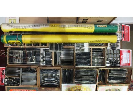A quantity of Minitrix N gauge flexible track: 50 x 75cm lengths and a large number of shorter lengths, points, crossings, in