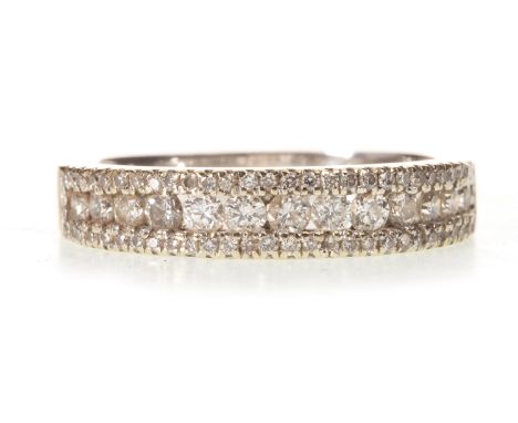 DIAMOND SET BAND, with channel set round brilliant cut diamonds within a border of smaller diamonds, marked 750, size K 1/2, 