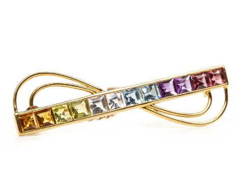 MULTICOLOUR GEM SET BAR BROOCH, set with purple, blue, green and orange gems, with waved section to either side, marked K18, 