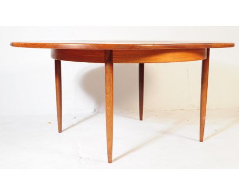 G Plan Furniture - British Modern Design - Mid 20th century retro teak dining table and four chairs. The oval table having dr