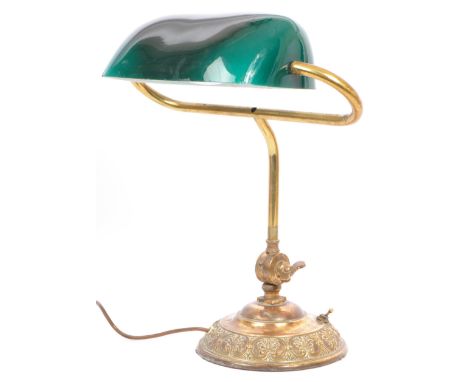 An early 20th century circa 1920s bankers lamp table light. The lamp having a forest green / teal blue cased glass shade over