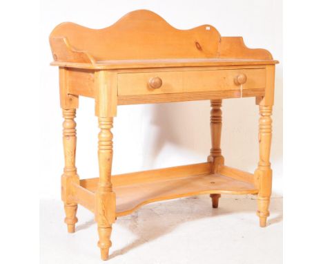 A Victorian country pine wash stand with shaped backsplash and sides.&nbsp; Supported on turned legs and lower shelf.&nbsp; S