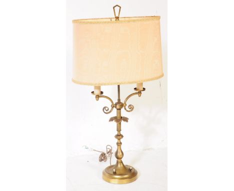 A vintage 20th century circa 1940s gilt metal twin arm table lamp. The lamp having spiral twin arms over a reeded shaft with 