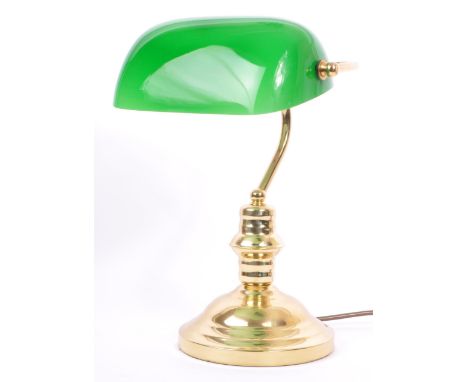 A vintage 20th Century bankers office table lamp light. Having a green glass swinging shade, with brass reeded support on a s