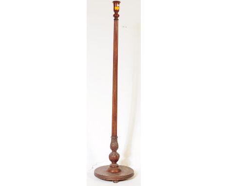 An early 20th century Edwardian circa 1910 mahogany floor standing standard lamp. The lamp having tapering reeded shaft termi