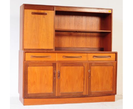 A G-Plan mid-century teak wood highboard / sideboard credenza. The cabinet having an open glass shelf and drop down cocktail 