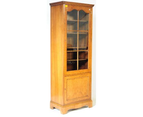 An Edwardian style sentry box walnut display cabinet by Cameo Furniture. The cabinet having twin doors opening to reveal shel