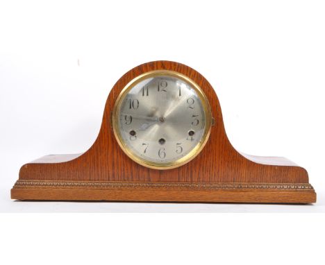 An early 20th century circa 1930s oak veneer Westminster chime napoleon tambour mantel clock. The clock having silvered face 