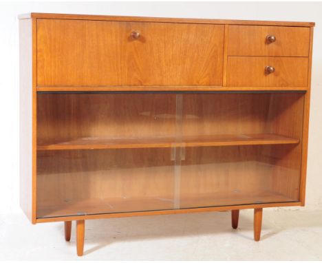 Avalon Furniture - A mid century retro teak wood library bookcase display cabinet. Raised on tapering legs with twin sliding 