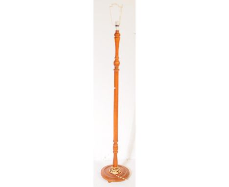 A vintage 20th century circa 1940s mahogany turned mahogany wood standard floor standing lamp raised on a circular base.&nbsp