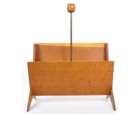 A mid 20th century teak magazine rack holder trough. With shaped trestle legs, with metal tubular column with carry wooden kn