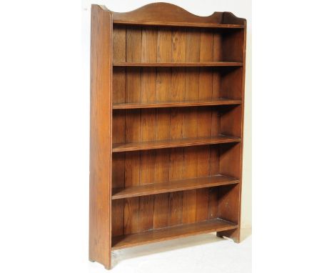 Large upright 1900's oak open window bookcase cabinet. Raised on shaped legs with panelled back rest having fixed shelves. Th