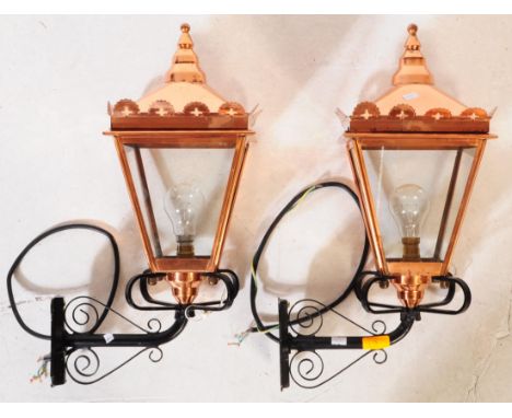 A pair of Victorian style contemporary wall mounted street lantern lamp lights. With a finial to top into a square tapering b