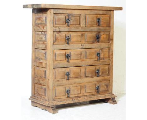 Contemporary hardwood chest of drawers. Splayed feet with an upright pedestal body of five block fronted drawers with drop ha