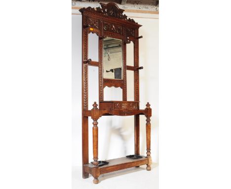 A 19th century Victorian mahogany carved hall / coat and stick stand. The hallstand / hall stand with intricate carved detail