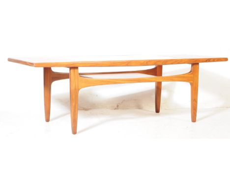 G Plan - British Modern Design - A teak wood 'Long John' coffee table, with glazed inset panel and magazine shelf under tier.