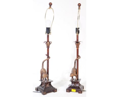 A pair of 20th century resin lamps having metal acanthus collar over shaft and base of neoclassical form with a pair of gilt 