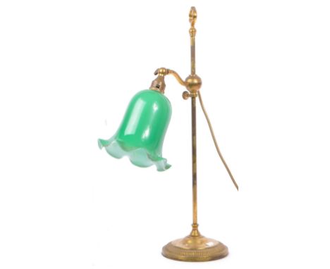 A vintage mid 20th century brass and tin plate table lamp. The lamp having green glass tulip shade on a brass hoop to upper f