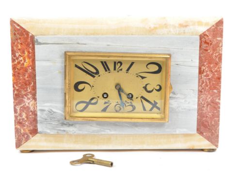 A 1930's Art Deco veined marble cased mantel clock. The clock having a yellow, rose pink and grey marble decoration&nbsp;thro