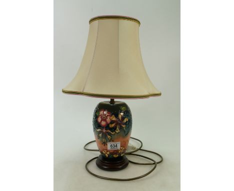 Moorcroft lamp base: on wooden base decorated  in the Oberon design with original factory shade overall height 47cm