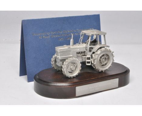 Pewter Ford TW-35 Tractor mounted on a wooden plinth marked Basildon Tractor Production 1984-1989. Presented to Ford tractor 