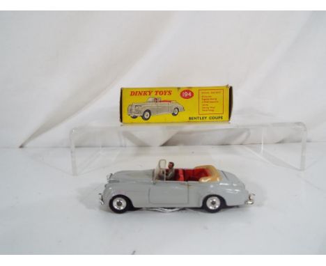 Dinky Toys - A Dinky Toys # 194 Bentley Coupe. Grey body, red interior and tan hood with spun hubs and grey driver, featuring