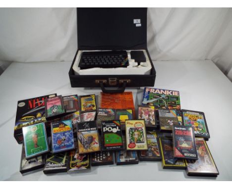 A Sinclair ZX Spectrum gaming computer with power pack, leads in a travel case with instruction manual and basic programming 