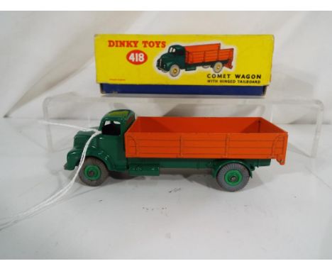 Dinky Toys - A Dinky Toys # 418 Leyland Comet Wagon with Hinged Tailboard. Dark green cab, chassis and hubs and orange back (