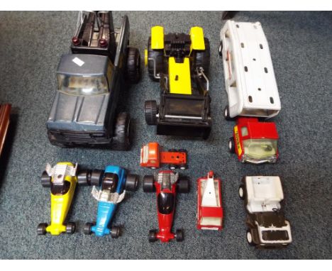 Tonka - nine metal vehicles by Tonka to include car transporter, tractor, racing cars and similar