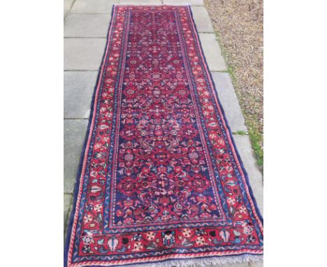 A fine hand woven Mahal runner with geometric flower head design on rich navy field - 318cm x 110cm 