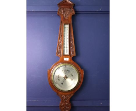 EDWARDIAN WHEEL BAROMETER AND THERMOMETER, contained in a carved oak case
