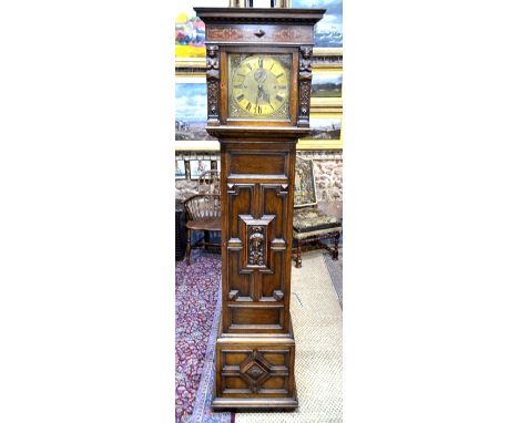 Maple, London, a Flemish Revival style oak 8-day longcase clock, the movement chiming on five coiled gongs with brass dial in