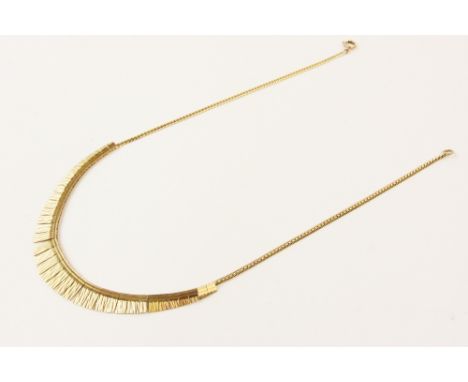A 9ct gold fringed collarette, the tapering fringe drop with engine turned decoration, measuring between 3mm and 10mm, set to