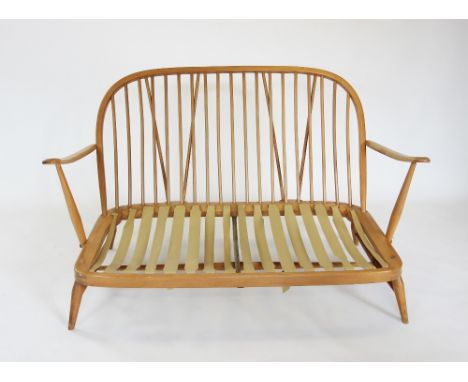 A mid 20th century Ercol light beech wood 'windsor' three piece lounge suite, comprising two seater sofa with a hoop stick ba