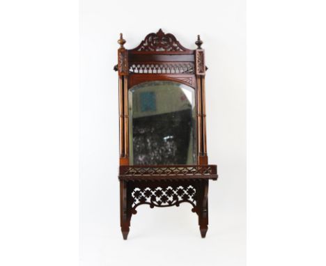 An early 20th century Chinese Chippendale revival mirrored wall bracket, the arched bevelled mirrored plate flanked by twin r