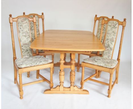 A late 20th century Ercol blonde elm extending dining table with four chairs, the rectangular tapering table top with three e