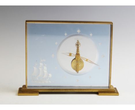 A Jaeger Le Coultre Marina mantel clock, the rectangular lacquered brass and lucite panel inset case enclosing a design featu